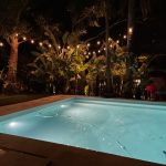 Pool with hanging lights and trees