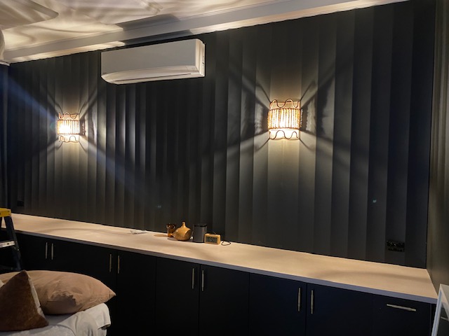 Black wall with light and aircon attached